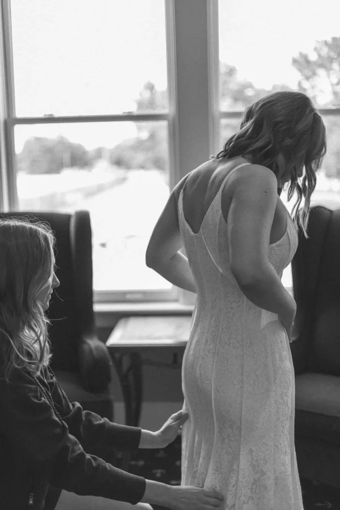 bride tries on her wedding dress