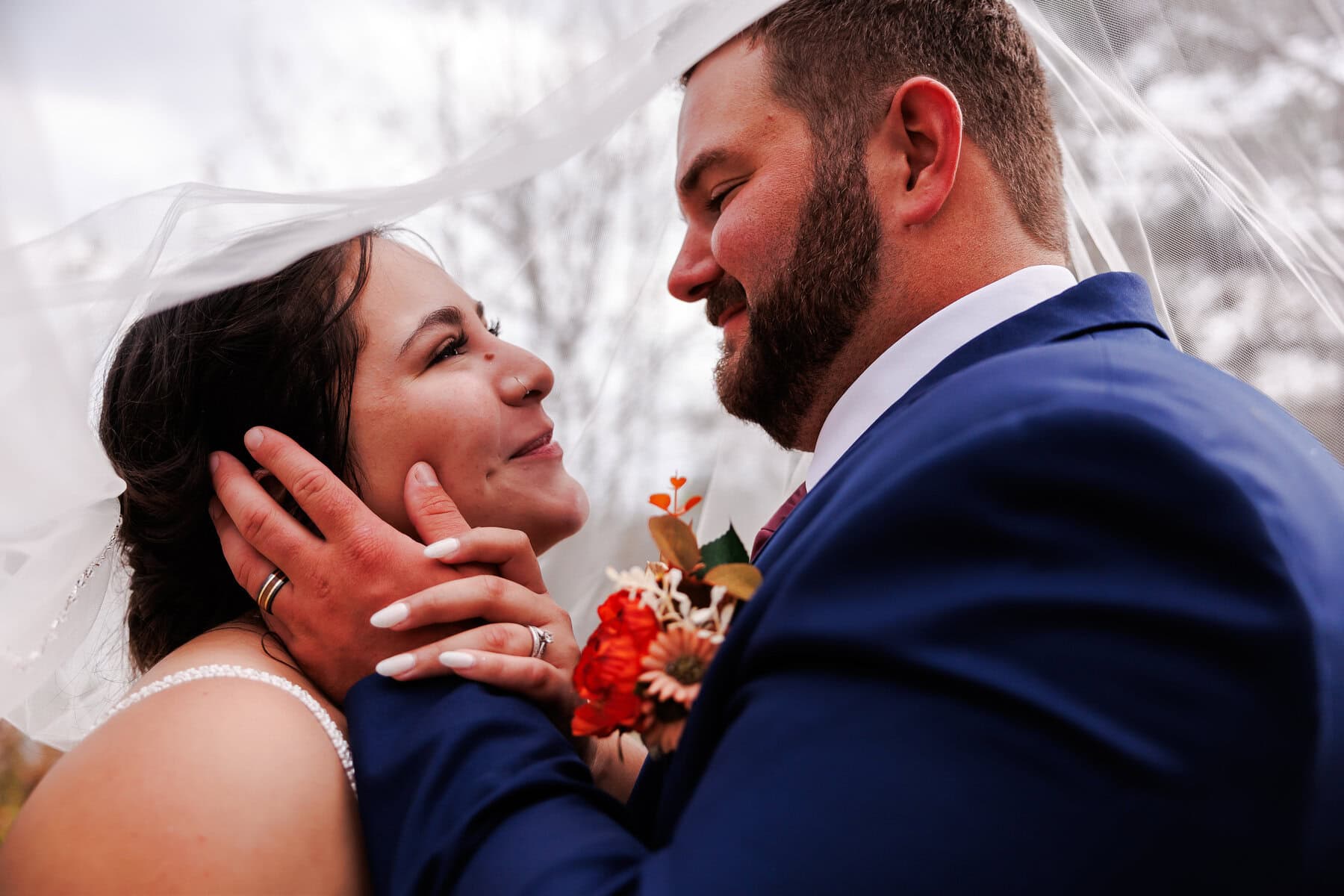 bride and groom under a veil at their Two Harbors MN wedding