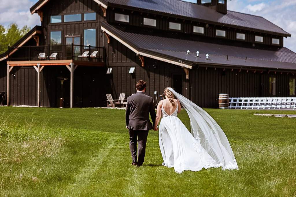 bride and groom walk to wedding venue called Ivy Black