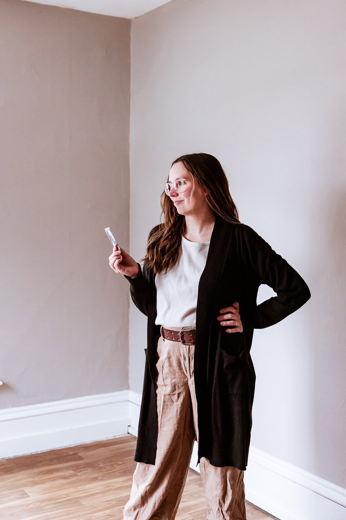 A minnesota wedding photographer posing in studio with film print.