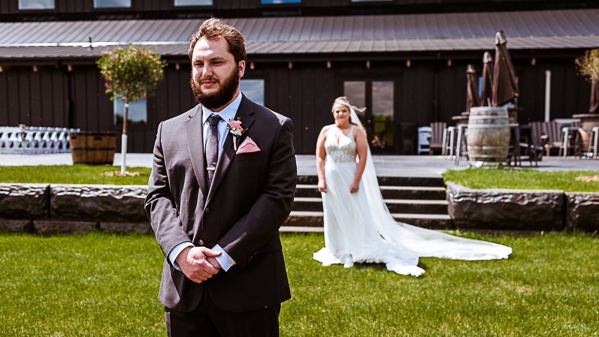 couple does their first look at ivy black for their wedding in saginaw mn