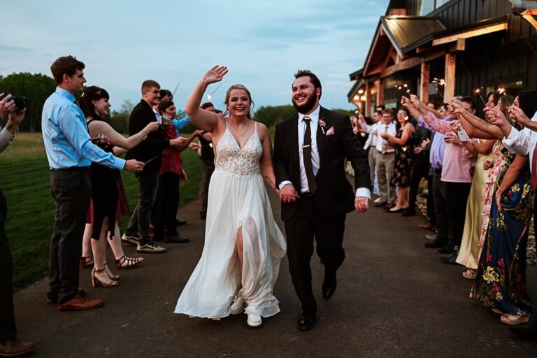 couple exits through a sparkler line at their ivy black wedding in saginaw mn